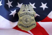 Border Patrol badge resting on an American flag
