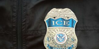 Close-up of an ICE officer badge on a black jacket