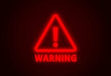 CDC Director Shrugs Off Deadly Virus Red neon warning sign with an exclamation mark
