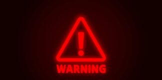 Red neon warning sign with an exclamation mark