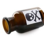 Brown glass bottle with skull and crossbones label