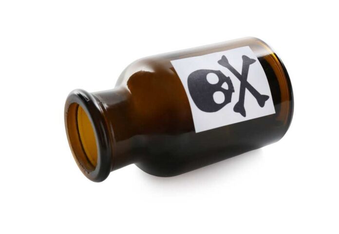 Brown glass bottle with skull and crossbones label