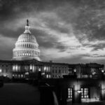 Capitol Cops Battle $1.7 Billion Trump Fund U.S. Capitol building at dusk, black and white photograph.
