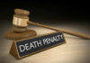 Shocking Double Murder: Death Penalty Demanded! Gavel beside death penalty sign on desk