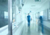 Ebola ALERT: Dangerous Strain Crosses Border! Hospital corridor with IV drip and healthcare worker.