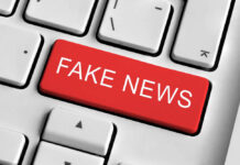 Close-up of a keyboard with a prominent red key labeled 'FAKE NEWS'