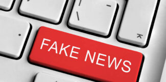 Close-up of a keyboard with a prominent red key labeled 'FAKE NEWS'