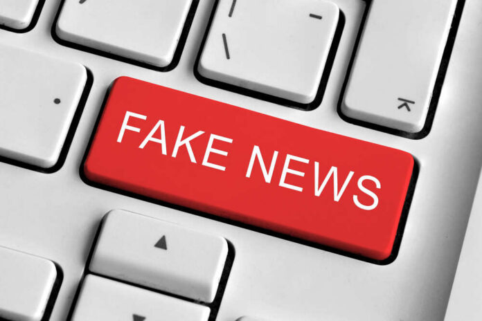 Close-up of a keyboard with a prominent red key labeled 'FAKE NEWS'