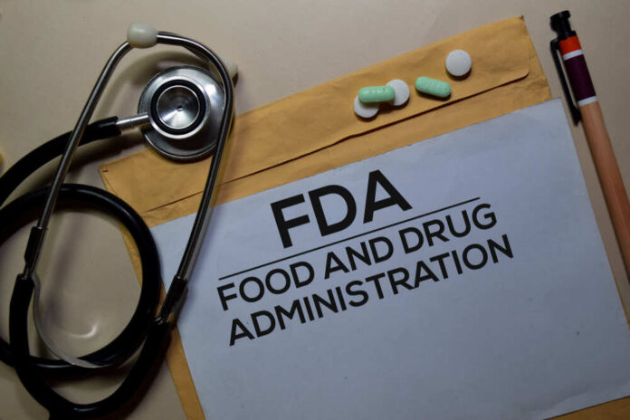 Fda,-,Food,And,Drug,Administration,Text,On,Document,Above Stethoscope and medication on a folder labeled FDA