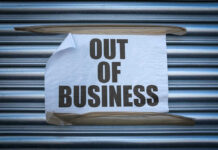 Retail Bloodbath Looms As 59 Stores Close Out of Business sign on closed store shutters.