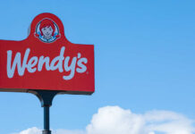 Wendy's restaurant sign against a clear blue sky