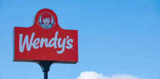 Wendy's restaurant sign against a clear blue sky
