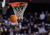 Basketball swishing through a hoop during a game