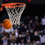 Basketball swishing through a hoop during a game