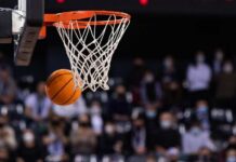 Basketball swishing through a hoop during a game