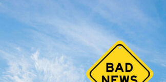Yellow sign reads bad news in sky