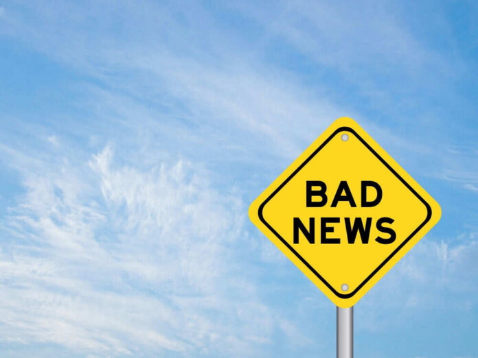 shutterstock_2265927471 Yellow sign reads bad news in sky