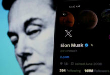 Wall Street Whiplash: Math Vs. Musk Elon Musks profile on mobile screen, blurred background face.