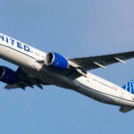 Airplane flying in clear blue sky daytime