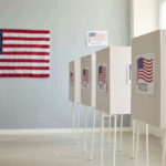 Court Supercharges Red State’s Voting Map Polling booths with American flags and Vote signs.