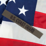 U.S. Coast Guard patch on American flag.