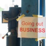 Fast-Food Pay Hike Backfires — CLOSED! Sign stating 'Going out of Business' attached to a pole