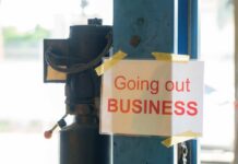 Fast-Food Pay Hike Backfires — CLOSED! Sign stating 'Going out of Business' attached to a pole