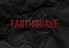 Crumpled black paper with the word 'EARTHQUAKE' in bold red letters