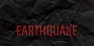 Crumpled black paper with the word 'EARTHQUAKE' in bold red letters