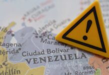 Trump Claims Joint Kill With Venezuela A close-up of a map of Venezuela with a yellow warning sign