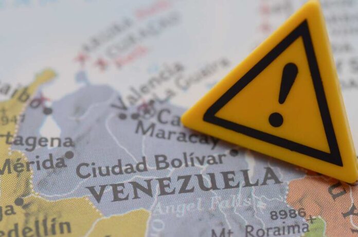 Venezuela,Crisis,Warning,Sign,On,Map,,Travel,Advisory,And A close-up of a map of Venezuela with a yellow warning sign