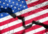 Communist Pipeline Into U.S. Revealed?! Cracked United States flag on textured surface.