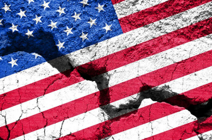 shutterstock_485930149 Cracked United States flag on textured surface.