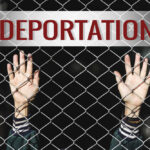Hands reaching through a chain-link fence with the word 'DEPORTATION' above