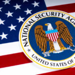 Spy Chief Shock: Wall Street Enforcer Tapped National Security Agency logo on American flag background.