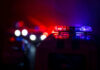 Vacation Ends With Child In Morgue Police car lights shining in the dark.