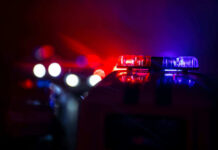 Vacation Ends With Child In Morgue Police car lights shining in the dark.