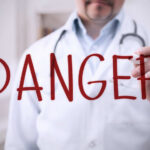 Walmart Recall Warning: Deadly Danger? Doctor writing danger on transparent screen
