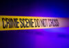Yellow crime scene tape with the words 'CRIME SCENE DO NOT CROSS'