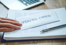Showdown: 100,000 Jobs On The Line A hand resting on an envelope labeled 'YOU'RE FIRED' on a desk with papers and a pen