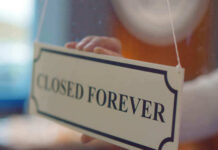 Pet Chain Gut-Punch: 75 Stores Axed Closed forever sign being placed on window.