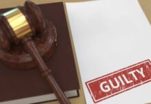 Epoch Times Finance Boss Drops Guilty Bomb Judge’s gavel on a book beside a paper stamped guilty