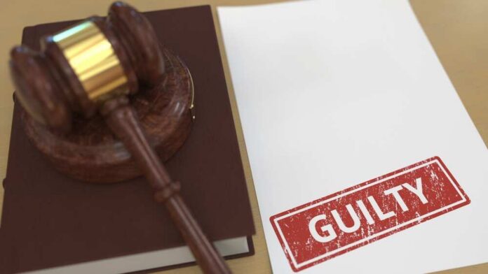 Judge,Gavel,And,Guilty,Stamp,On,The,Paper.,Court,Related Judge’s gavel on a book beside a paper stamped guilty