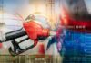 Gas Prices Plunge — What’s The Catch? Gas pump with financial data overlay and oil refinery in the background