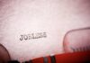 AI Pivot Triggers 9,000-Job Bloodbath Close-up of a typewriter with the word 'JOBLESS' typed on paper