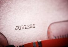 AI Pivot Triggers 9,000-Job Bloodbath Close-up of a typewriter with the word 'JOBLESS' typed on paper