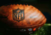 Bodycam Bombshell: Romo Stop Isn’t What You Think Close-up of an NFL football on grass.