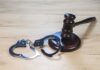 Fraudster Returns To Prison — Why So Little? Gavel and handcuffs on wooden table