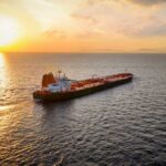 Oil tanker sailing at sunset on open sea