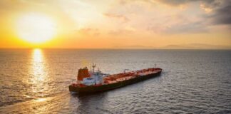 Oil tanker sailing at sunset on open sea